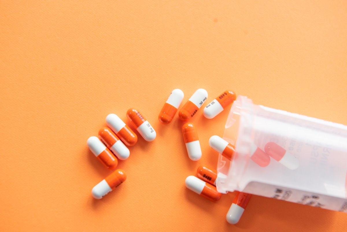Assorted prescription medication bottles on a pharmacy counter